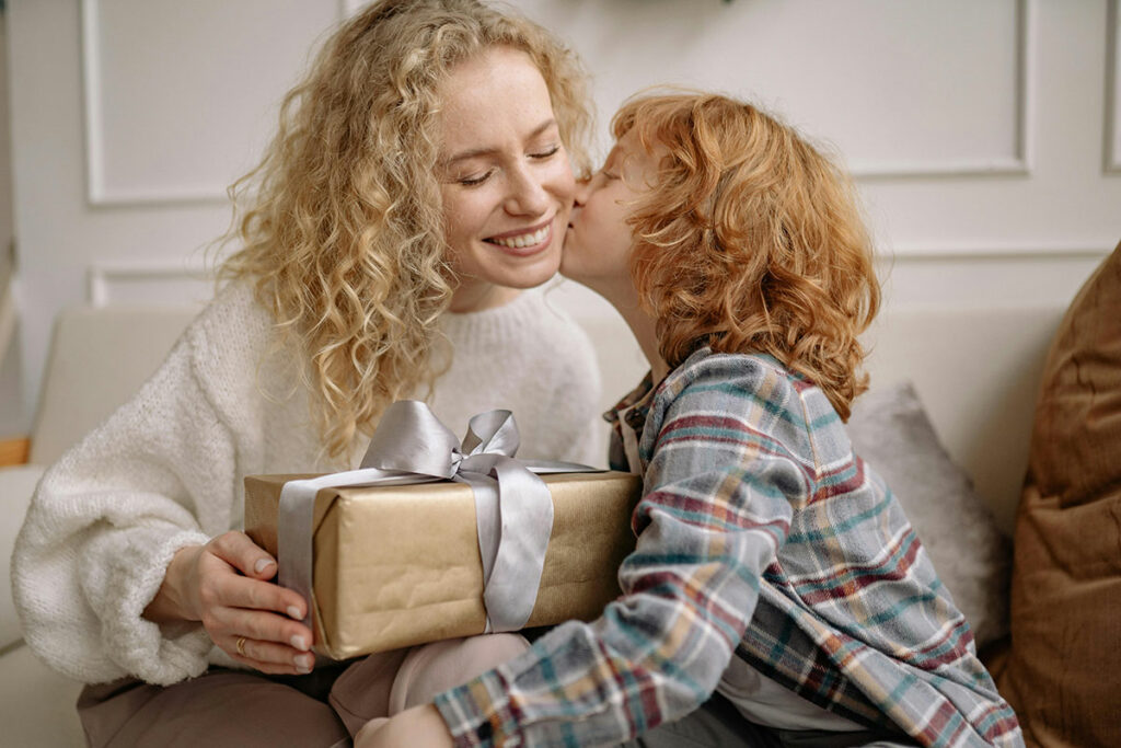 Son giving a gift to his mother